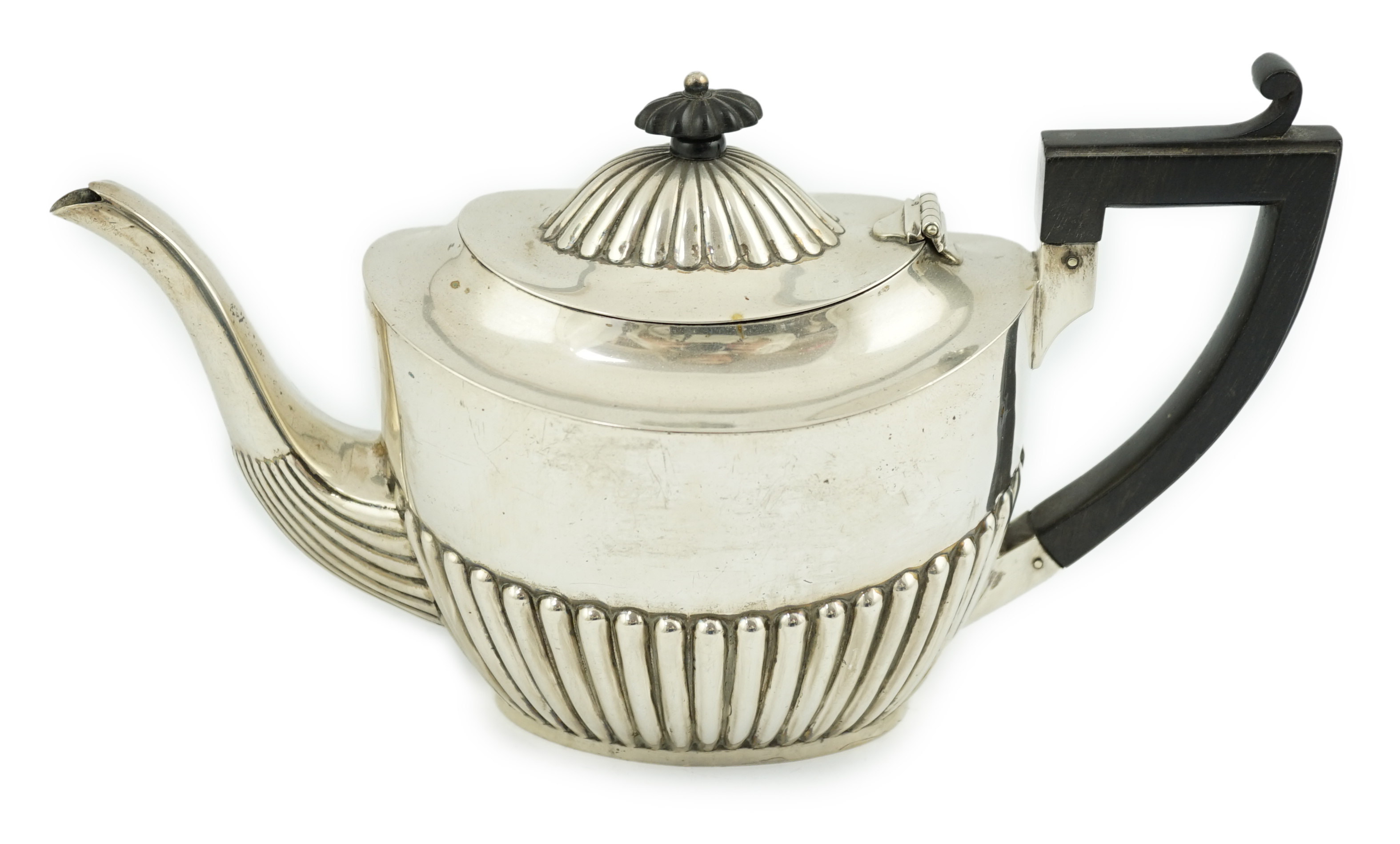 A late Victorian demi-fluted silver oval teapot, Nathan & Hayes, Chester, 1900, gross weight 17.1oz. Condition - fair.